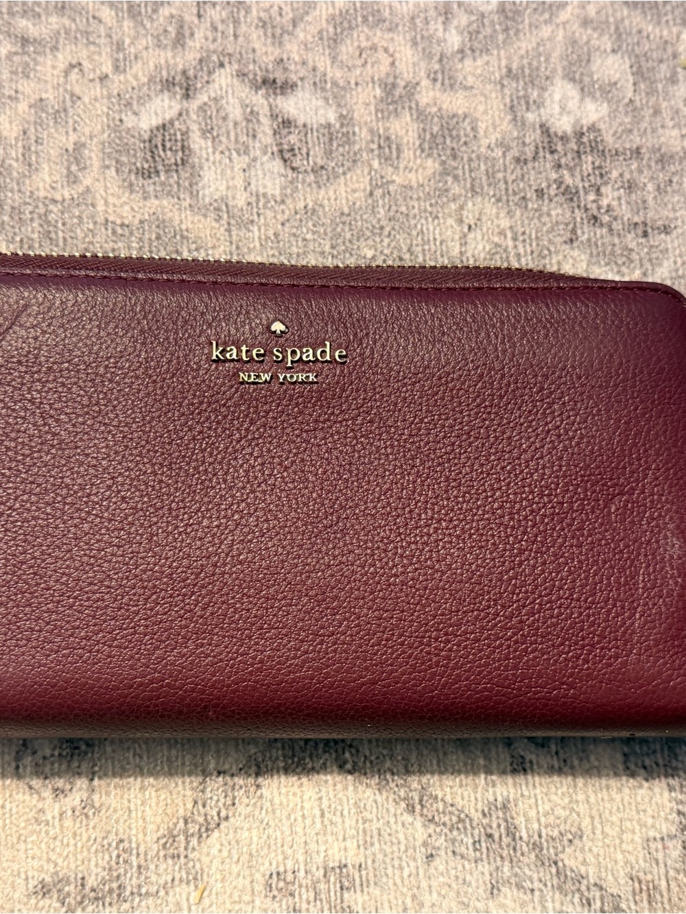 kate spade Burgundy Pebbled Leather Zip Wallet with Gold Logo